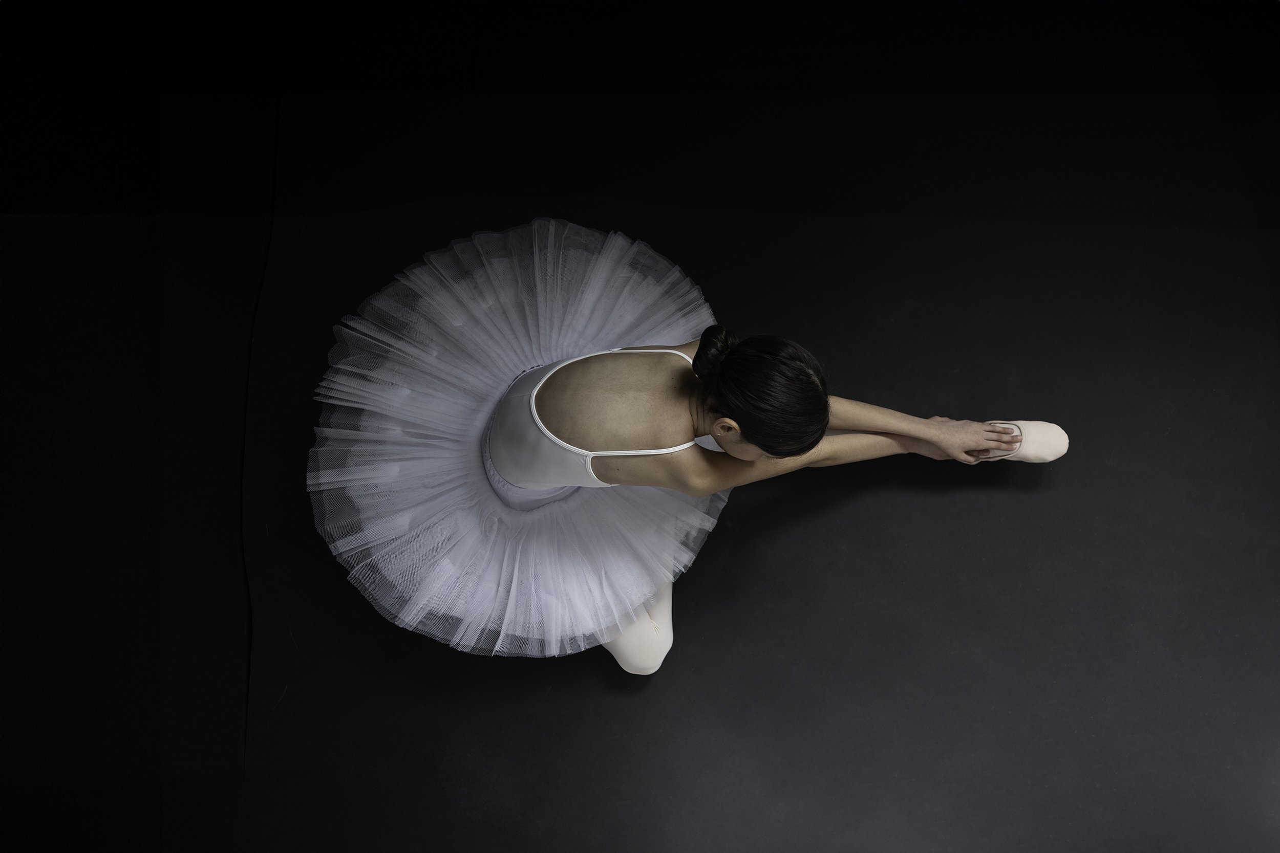 Woman seated with legs in front of her during Motion Dance Portrait Session with Beauclair Photography