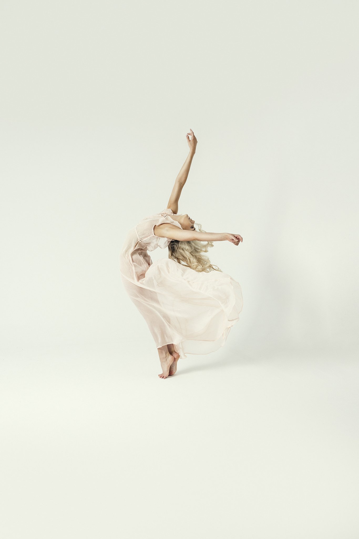 Woman with arms in the air leaning backwards during Motion Dance Portrait Session with Beauclair Photography