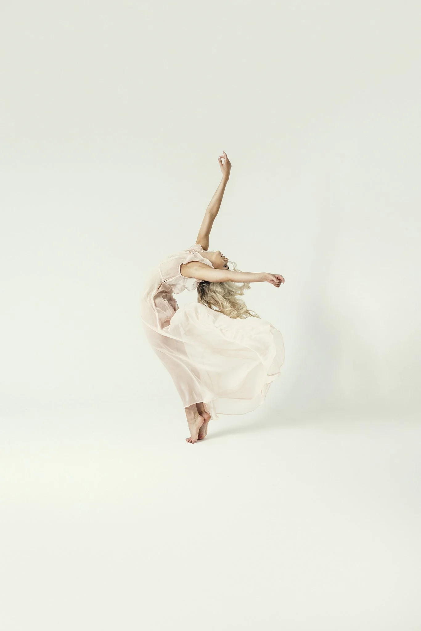 Woman with arms in the air leaning backwards during Motion Dance Portrait Session with Beauclair Photography
