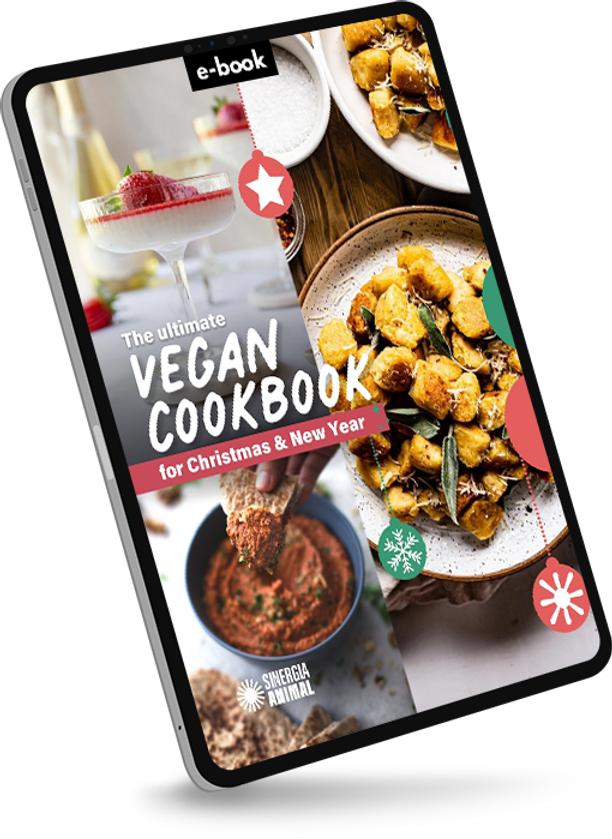 Cover of a vegan cookbook e-book titled "The ultimate vegan cookbook for Christmas & New Year" with images of vegan dishes and a dessert in a martini glass.
