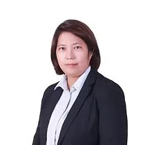 Professional woman with short dark hair wearing a black blazer and white collared shirt, facing forward against a white background.