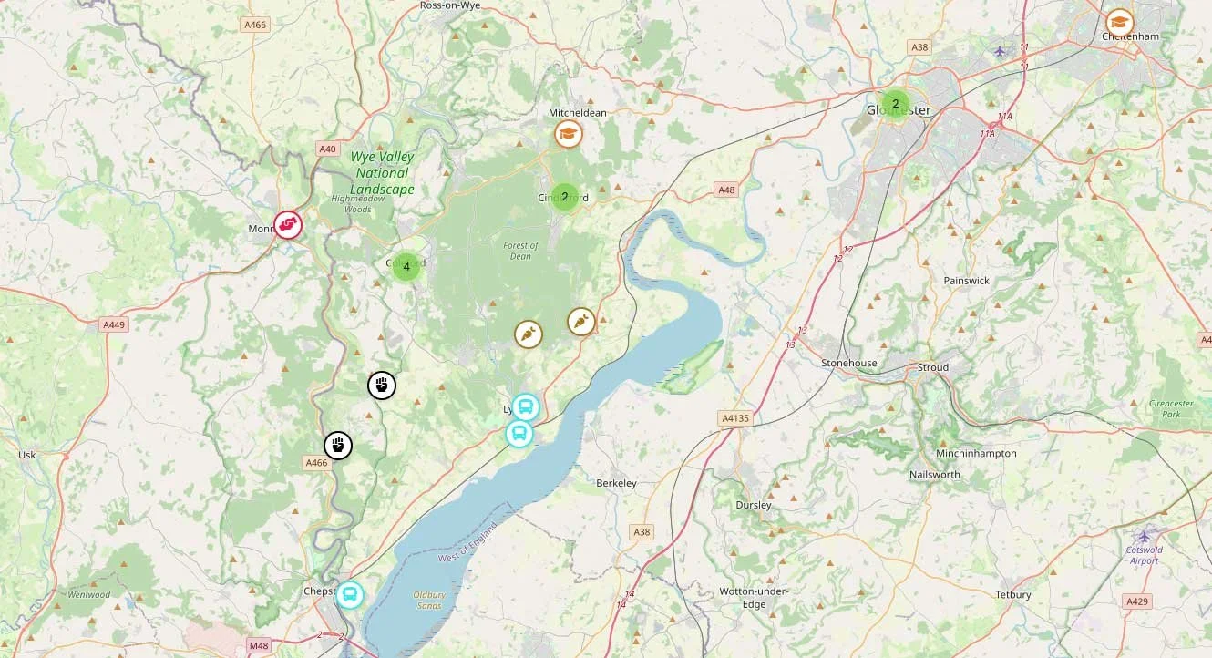 Map of Forest of Dean area showing the area between the Rivers Wye and Severn, with icons for points of interest, natural parks, and transport routes.