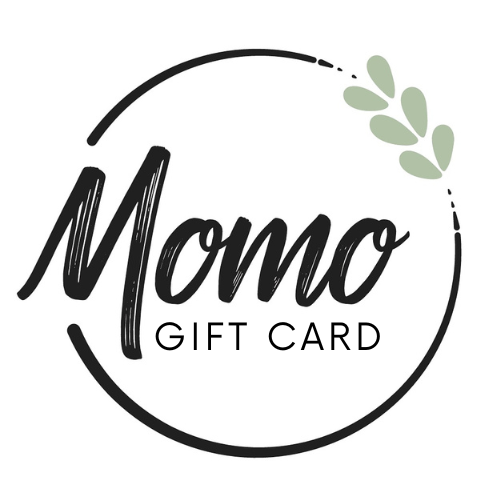 A modern design of a gift card with the text 'Momo Gift Card' inside a circular outline with a small green wreath on the upper right side.