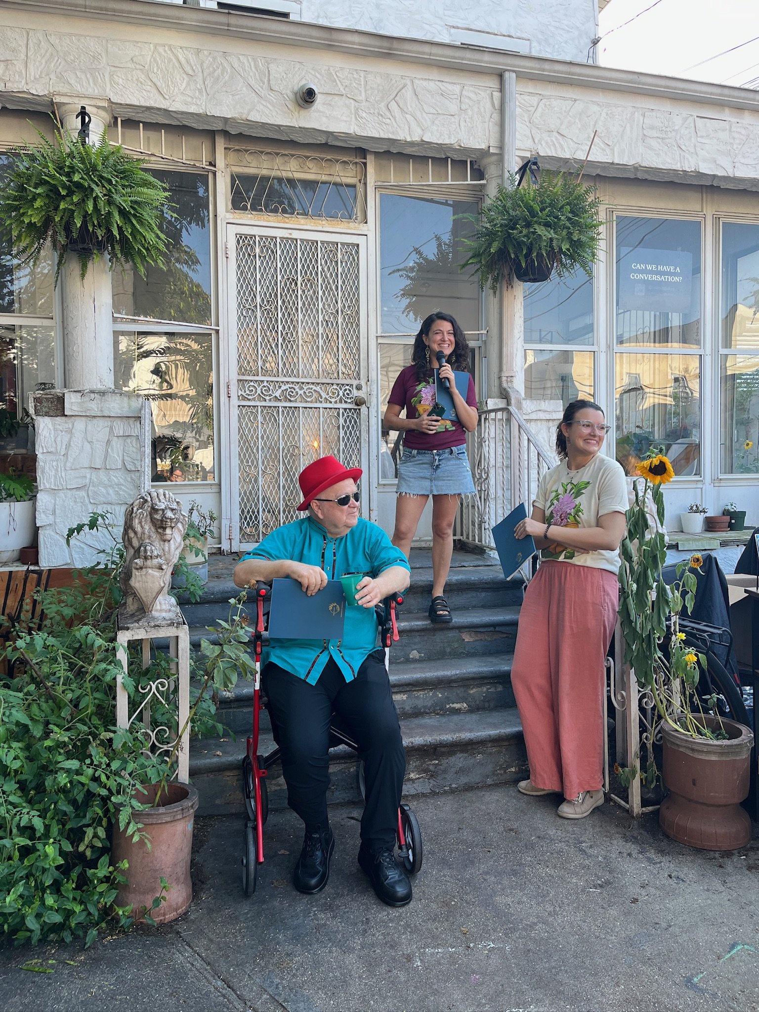 Libertroph co-founders, Alyssa & Julienne, alongside elder David Billings and vibrant sunflowers and plants, at the Libertroph Issue 01 Print Debut Party at Wyckoff House, Ridgewood, NYC, September 2025