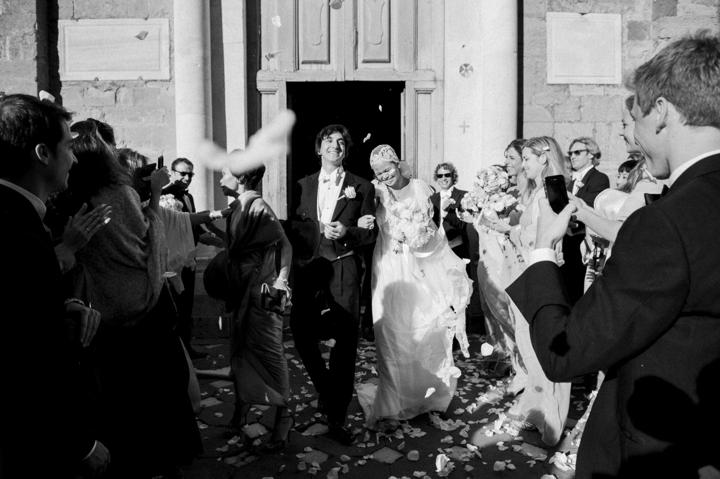 Black and White photography of a joyous bride and groom in Volterra, Italy