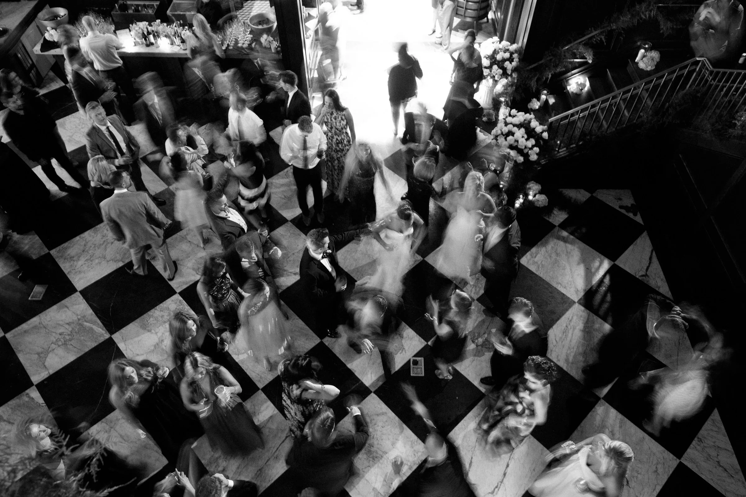Overhead black and white photograph of guests dancing at an Oxford Exchange wedding reception in Tampa, Florida.