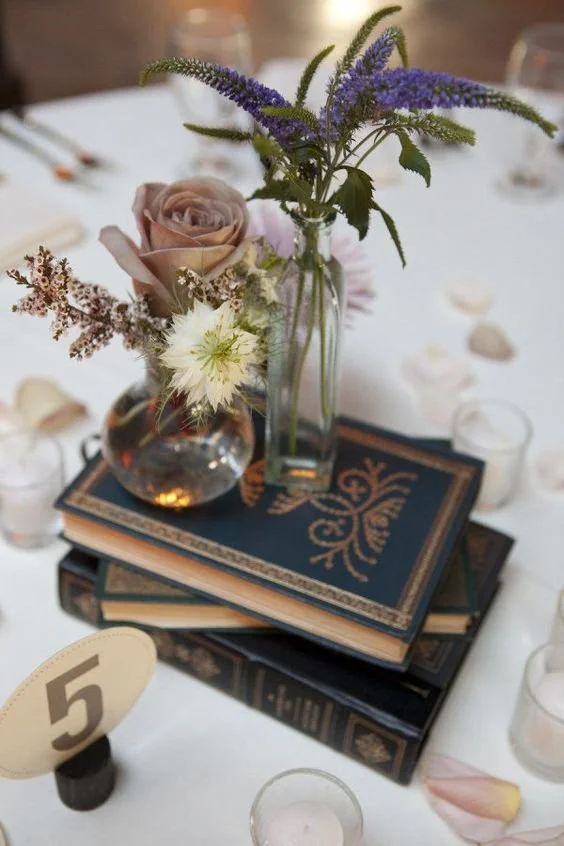 navy-books-two-clear-vases-with-simple-blooms-and-a-single-dusty-pink-rose-for-a-beautiful-look.jpg