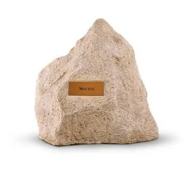Pet grave marker designed as a large rock with a plaque reading 'Stormy.'