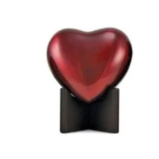Red heart-shaped decorative object on a black stand