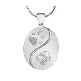 Oval pendant with a yin-yang design featuring paw prints