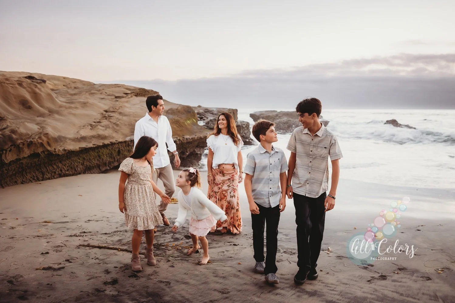 family of 6 walking on the beach
