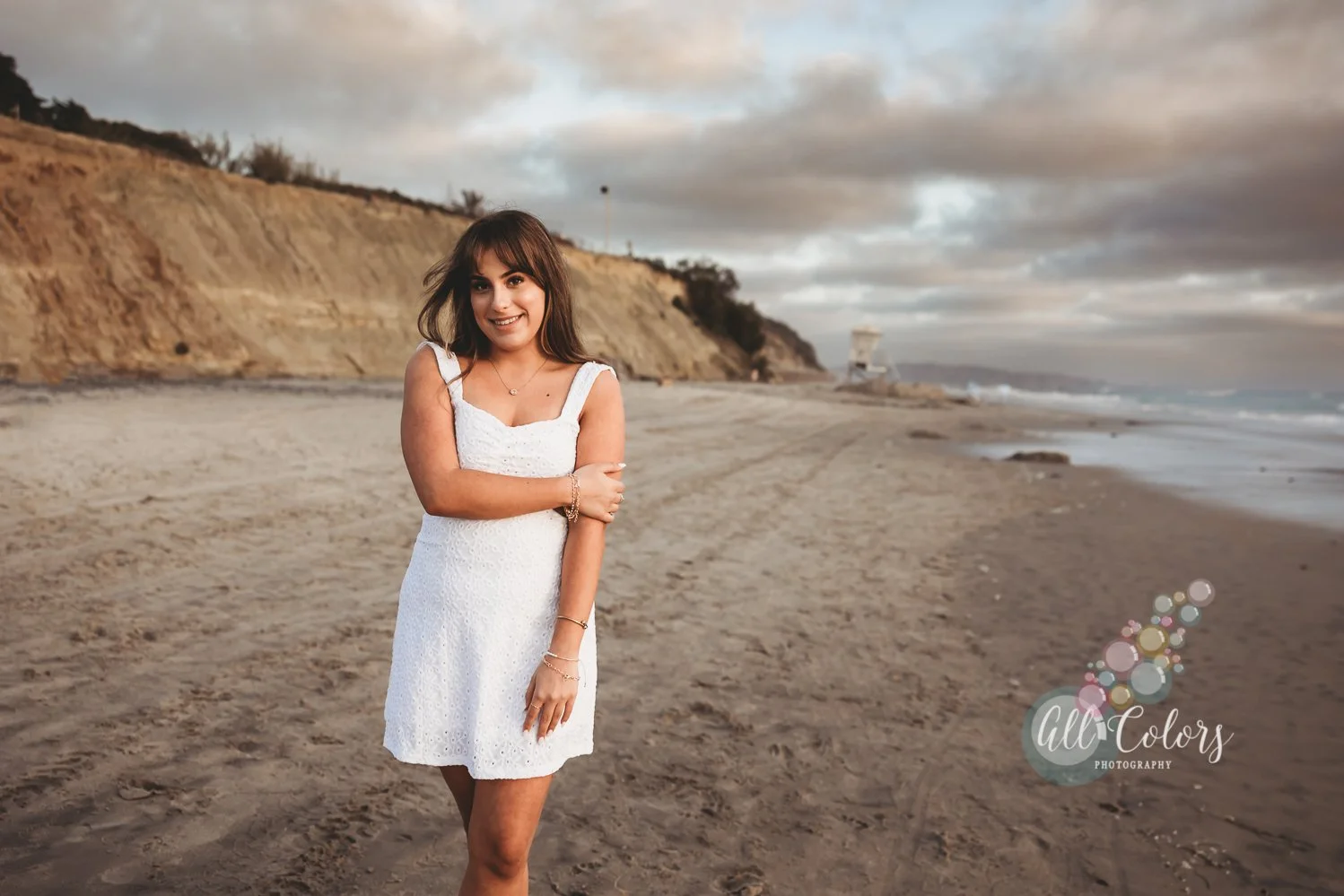 Girl wearing a white dress at the beach in Del Mar.