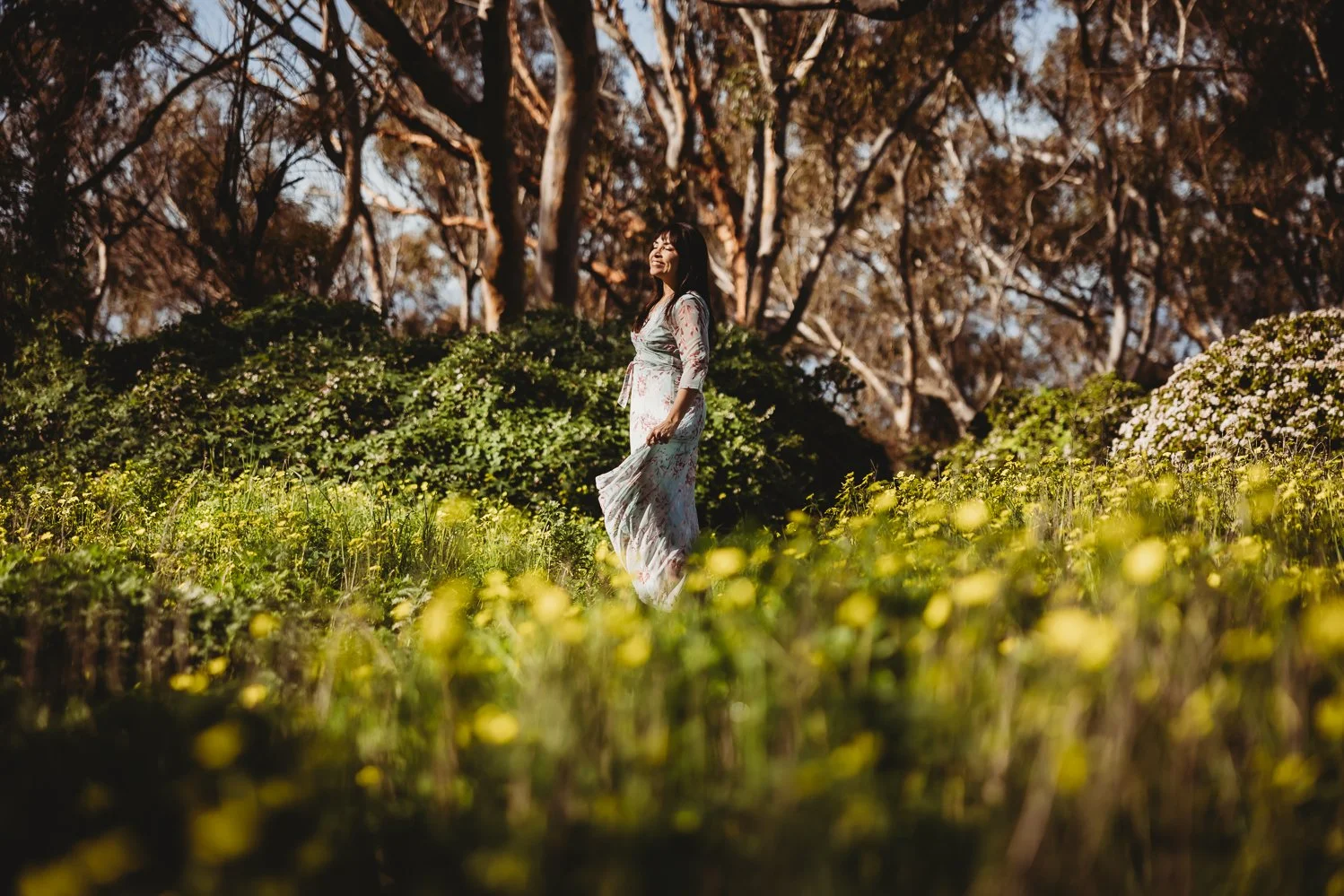 woman with her eyes closed on a field of flowers