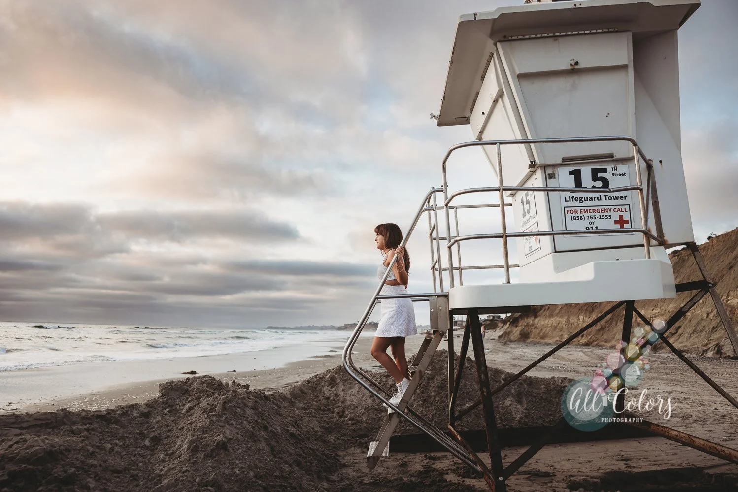 Girl wearing a white dress on a life guard tower