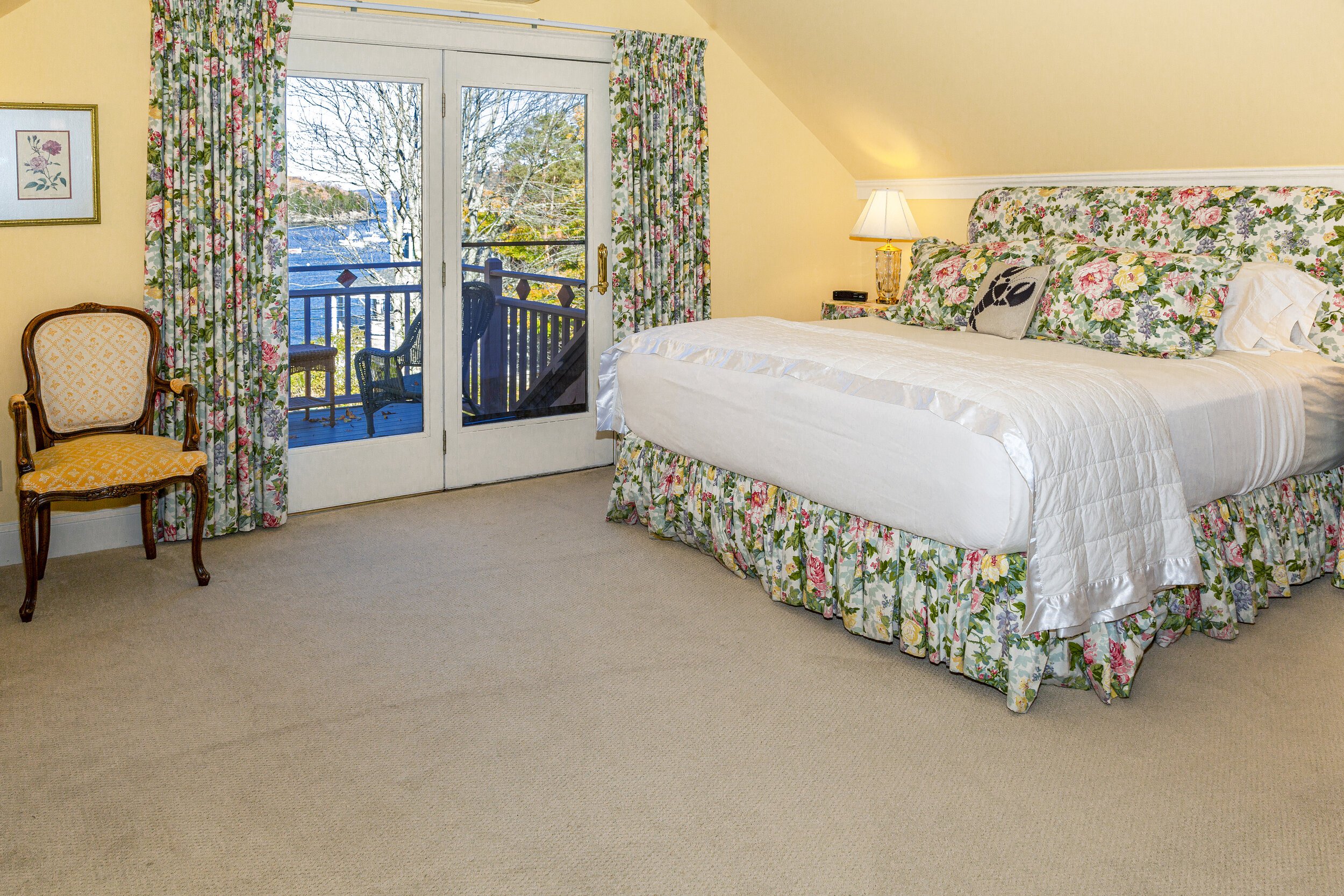 This is a spacious, third floor guest room featuring a large sitting area and a private terrace overlooking Frenchman Bay.