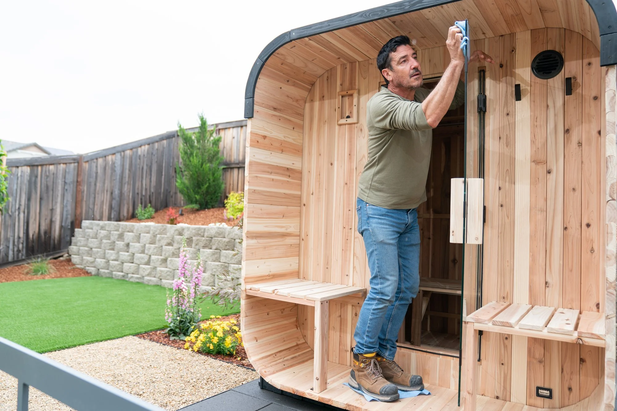 Detailing the cedar barrel sauna beside the new water-wise landscape during the 72-hour HGTV Crashers renovation