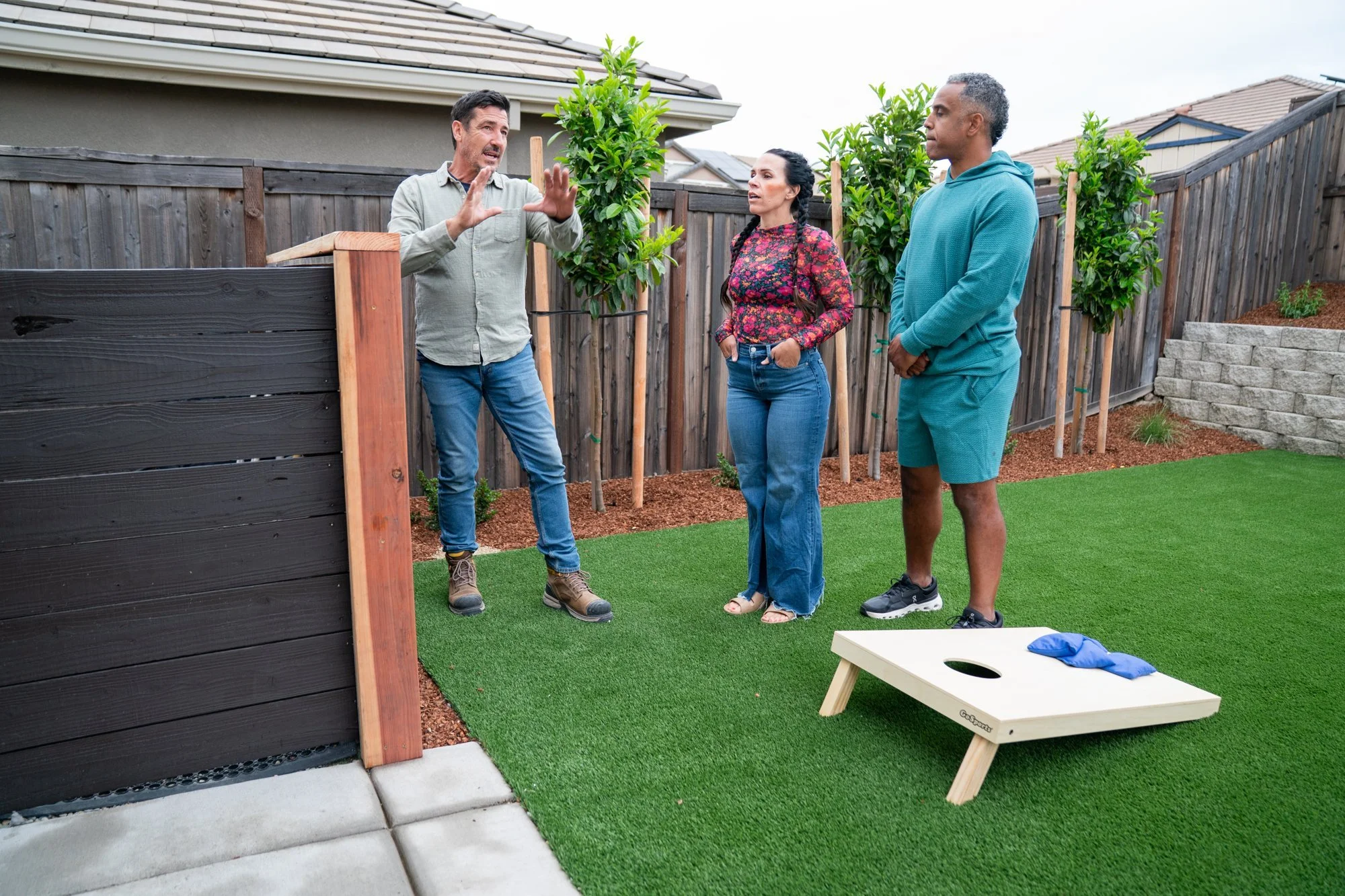 Host Jonathan Knight with the Roseville homeowners on the new synthetic lawn during the HGTV Crashers reveal
