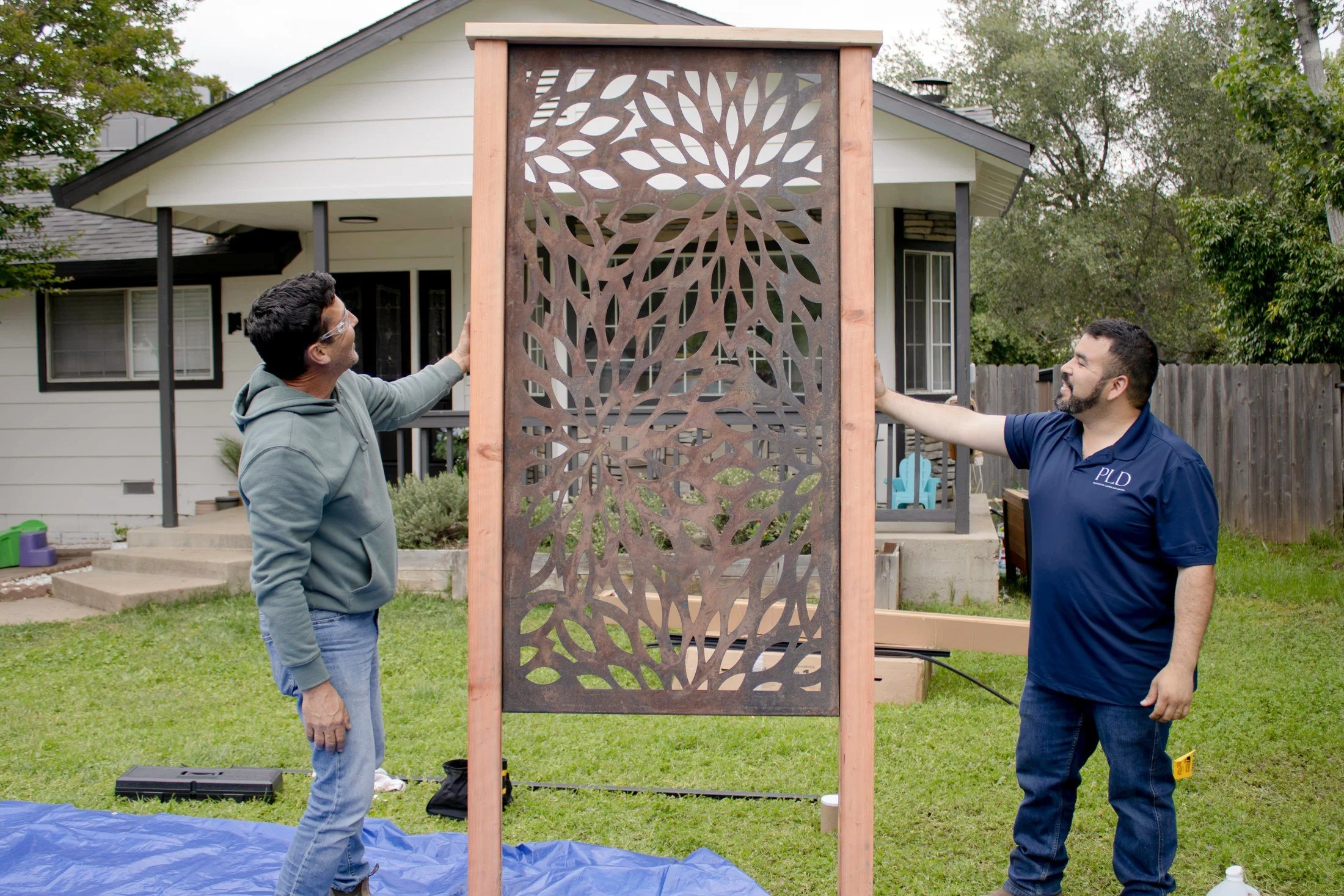 Palmatum owner Matthew Vasquez with HGTV Crashers host Jonathan Knight, setting one of the Corten panels during the build.