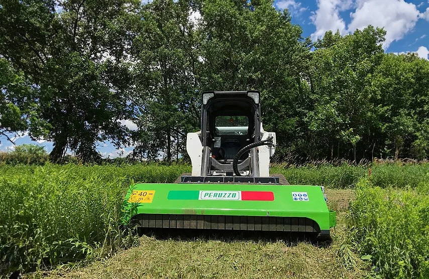 Flail mower machine mowing large brush and field