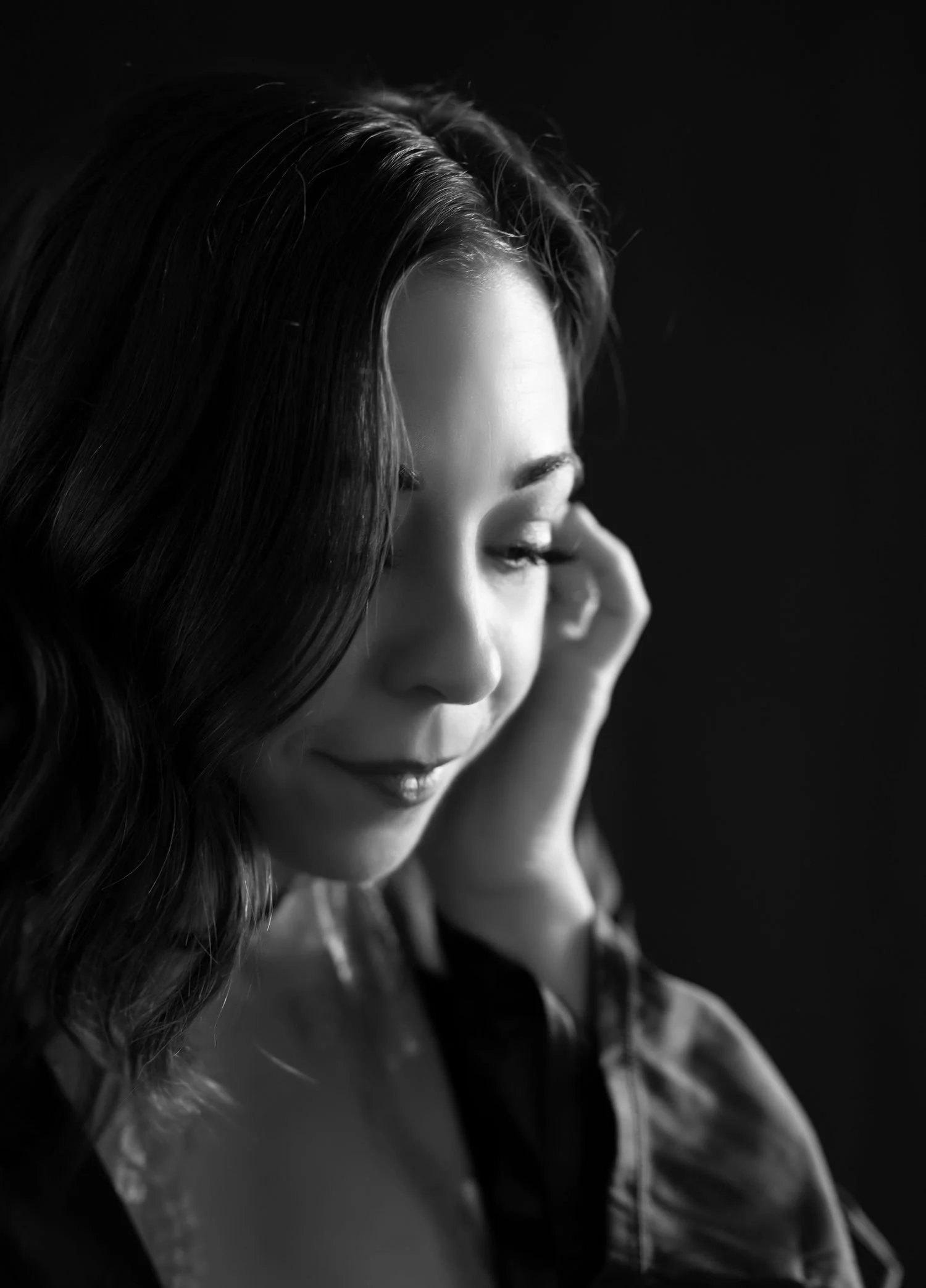 Black and white portrait of a woman in contemplation.