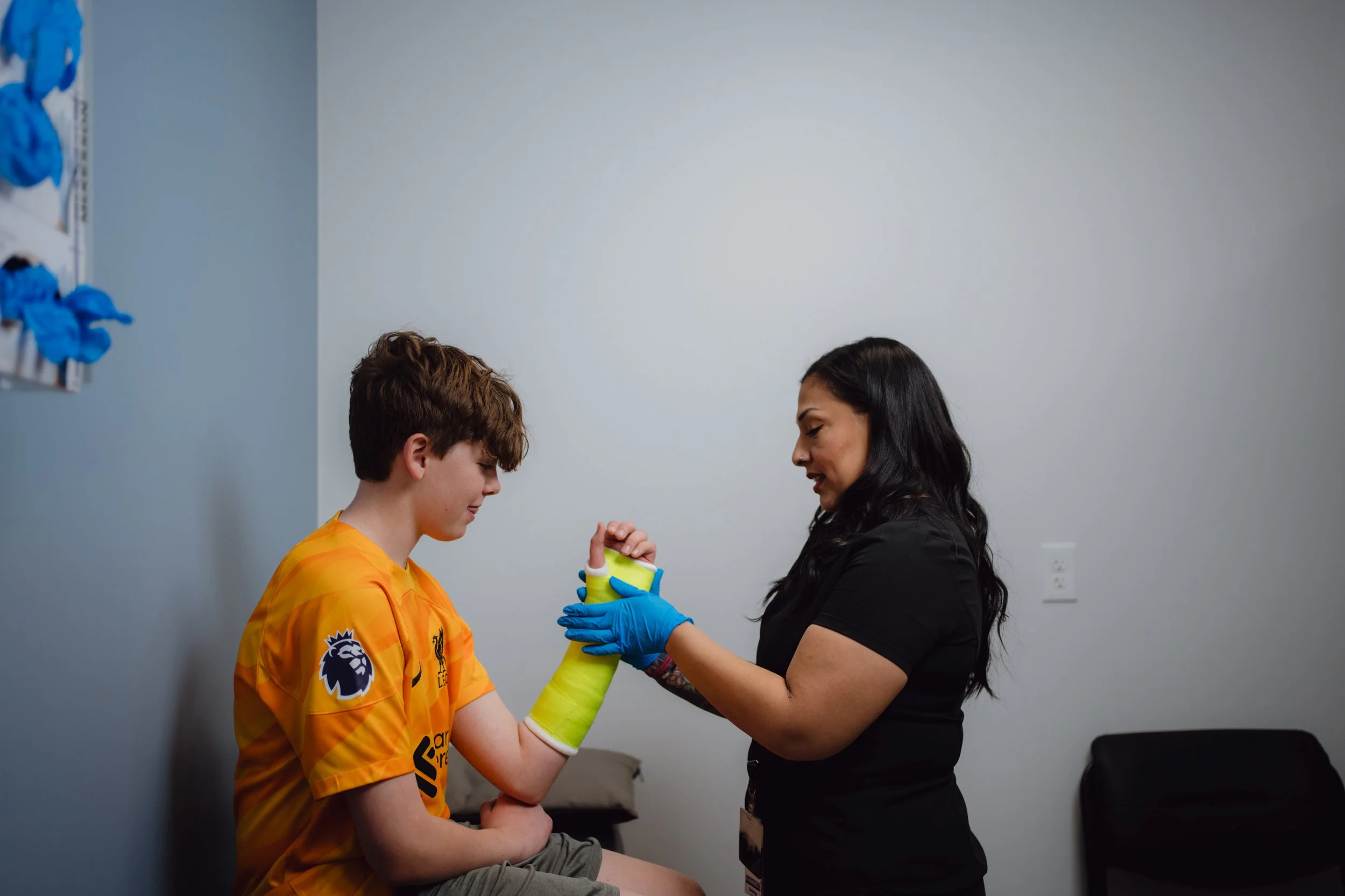 Orthopedic sports physician Dr. Rush providing shoulder care for an injured athlete.