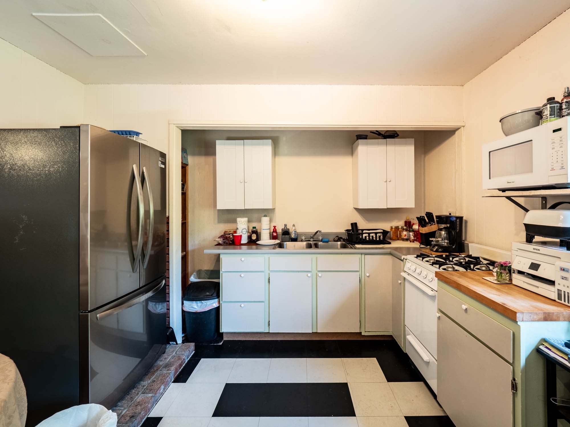 The Studio kitchen has a special charm with checkerboard flooring and retro cabinetry. It's compact, efficient, and designed for everyday use.