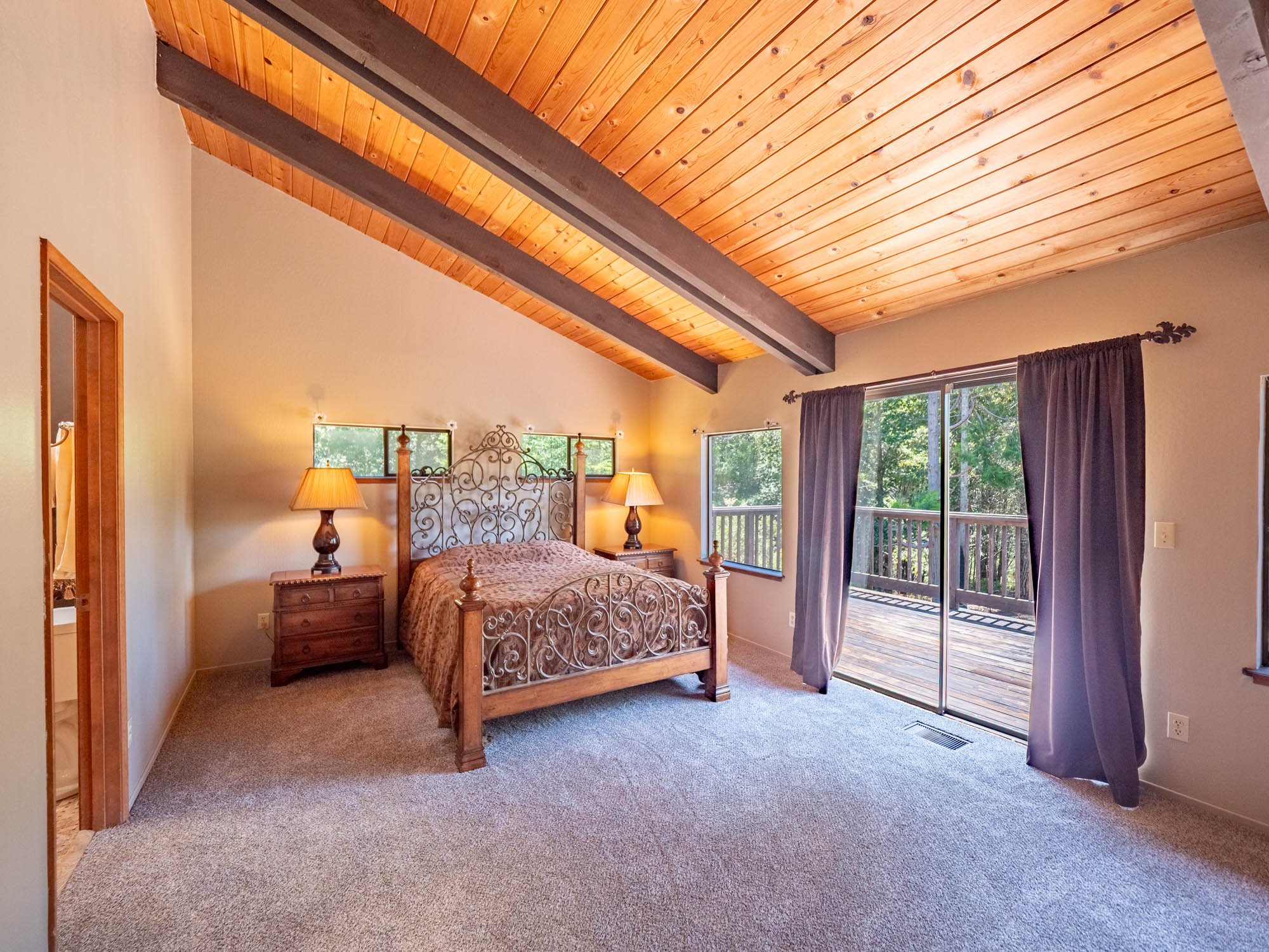 The beautiful Primary Suite with sliding door to a private deck area.