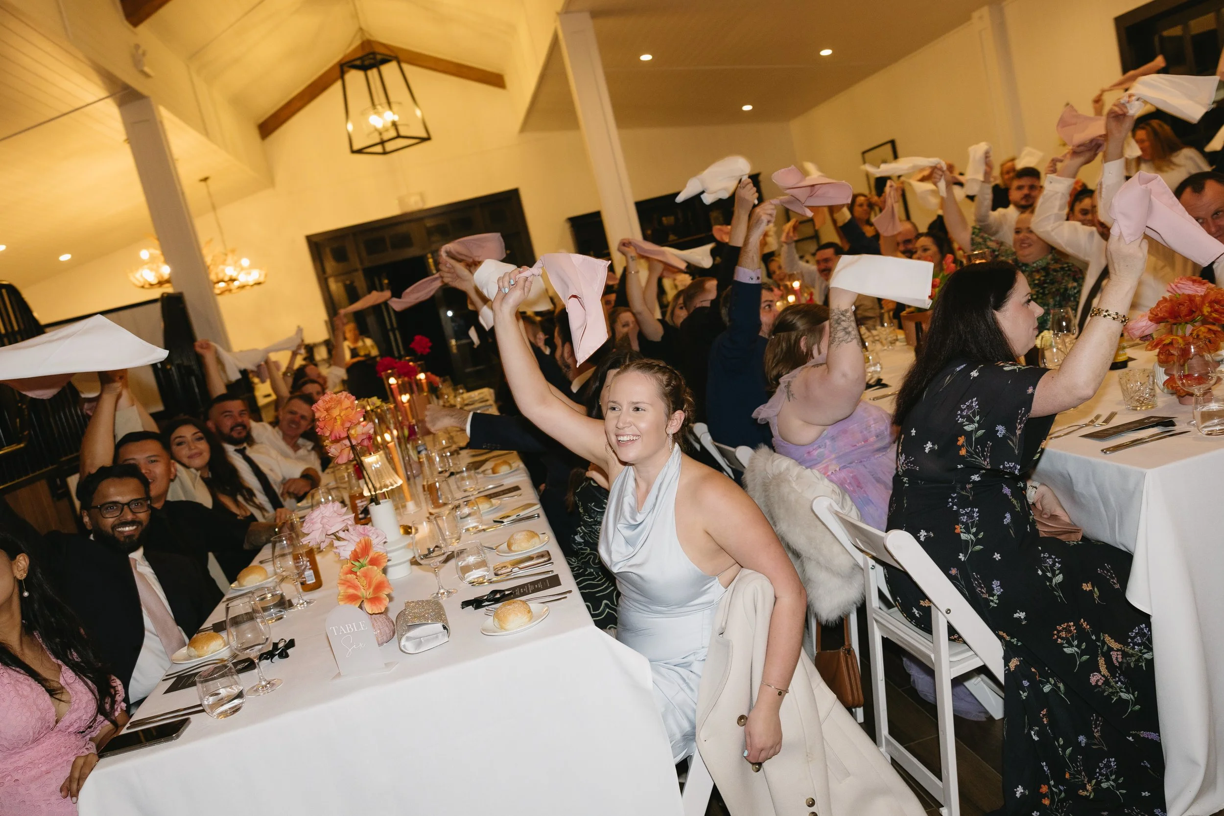 Wedding guests spinning napkins as they welcome the wedding party into the reception at Dark Horse Vineyard, Hunter Valley.  MC Bec Page The Love Page Celebrant