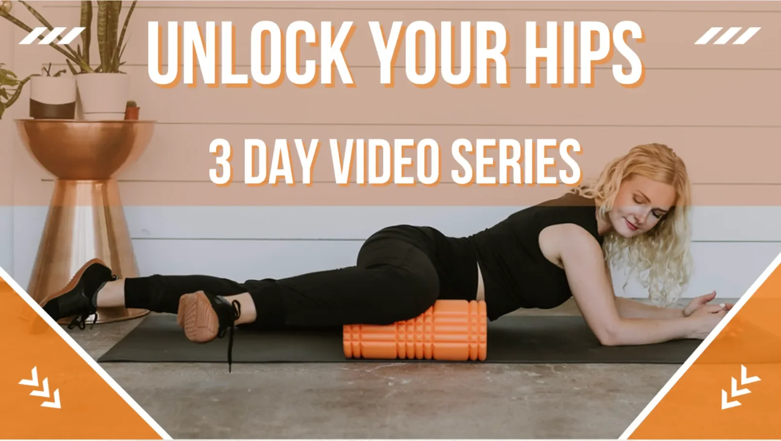 A woman with blonde curly hair doing an exercise on a yoga mat, using a foam roller for her hips. She is lying on her stomach with her head turned to the side, in a room with a potted plant and a wooden side table. Text overlay reads "Unlock Your Hips 3 Day Video Series."