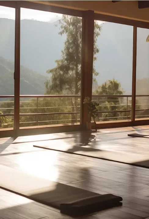 Peaceful movement studio with yoga mats, natural light, and mountain views.