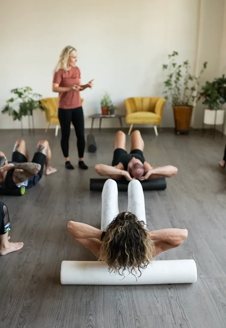 Group fascia release class with Julia teaching foam rolling and mobility exercises.