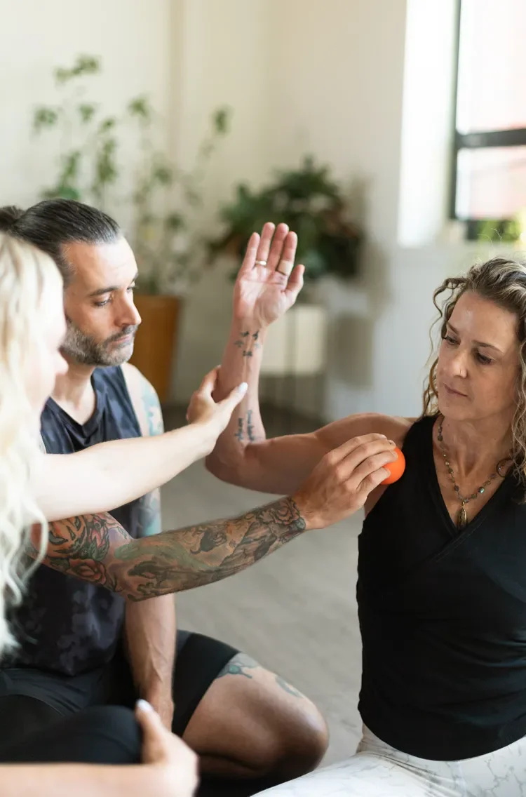 Partner-assisted fascia release class for shoulder mobility and movement awareness.