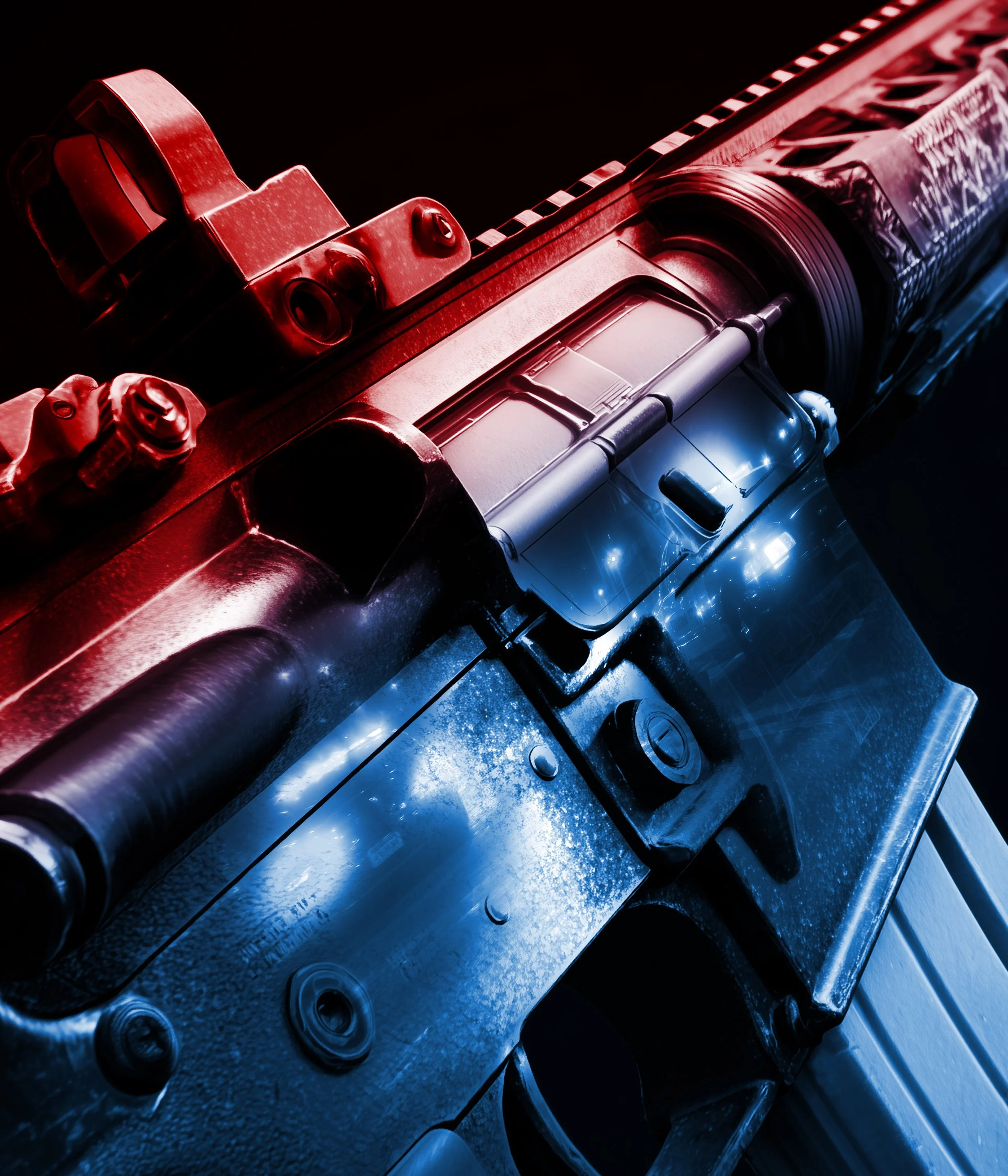 Close-up of a mechanical component with metallic surfaces, bolts, and cylindrical shapes illuminated by red and blue lighting.
