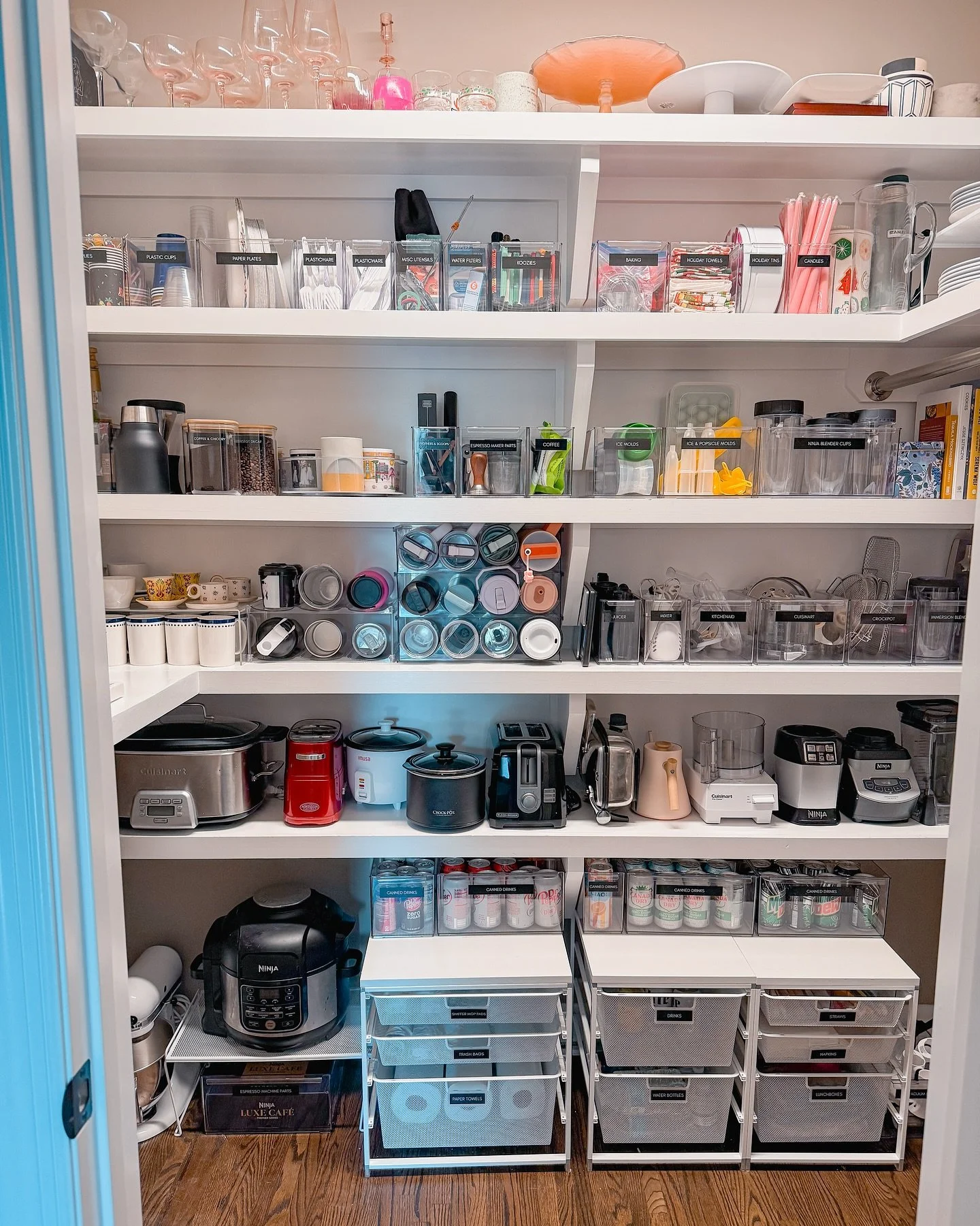 The kitchen closet of dreams: where everything has a home! ☕✨

This walk-in closet holds it ALL: small appliances with their accessories neatly organized, water bottles, special occasion dishes for entertaining, paper products, wine, and canned drink
