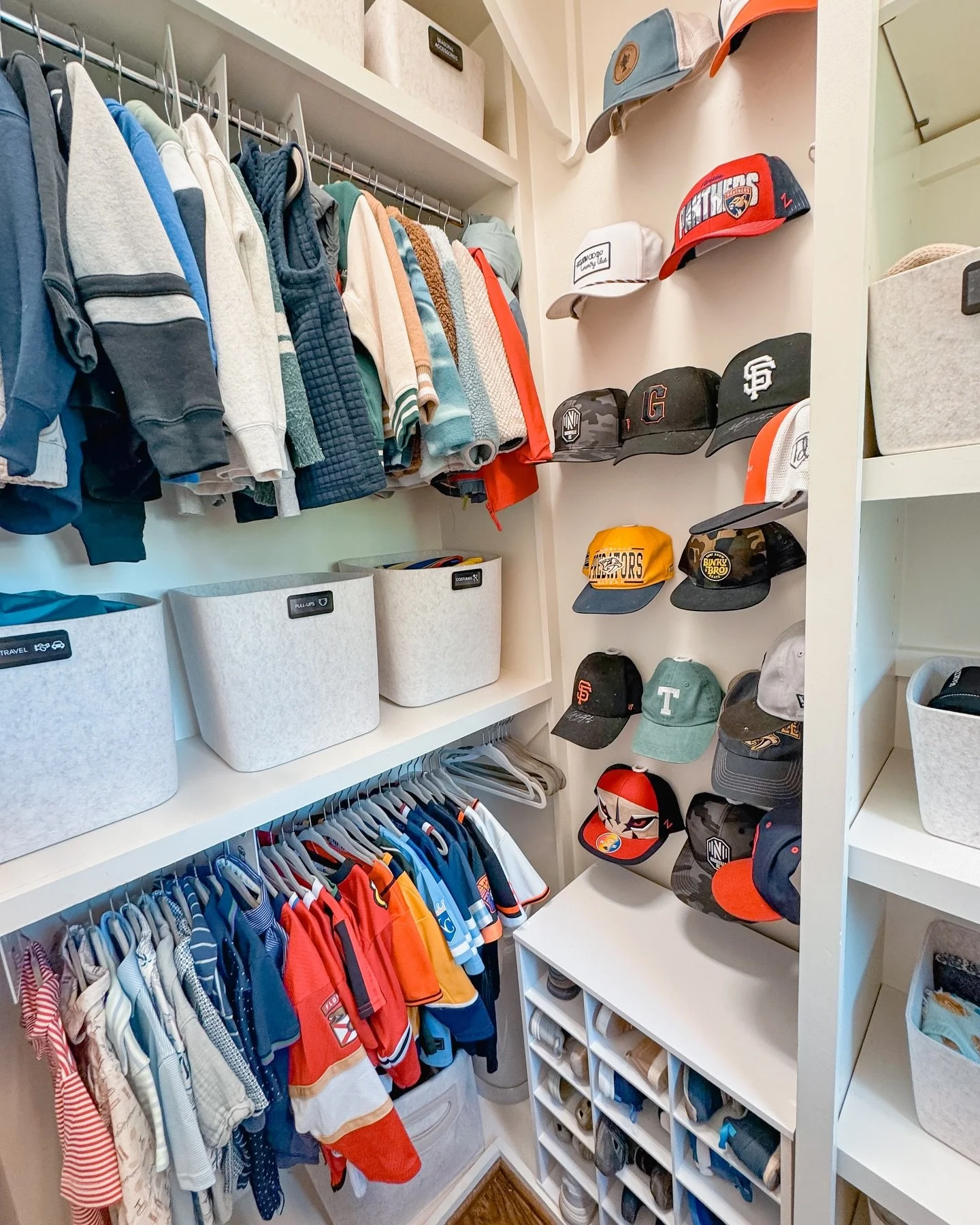 We love organizing for kids and this closet did not disappoint!

We added matching bins and rod dividers labeled with words and pictures to promote independence, hat hooks to display his collection, and drawer dividers that keep folded clothes in pla