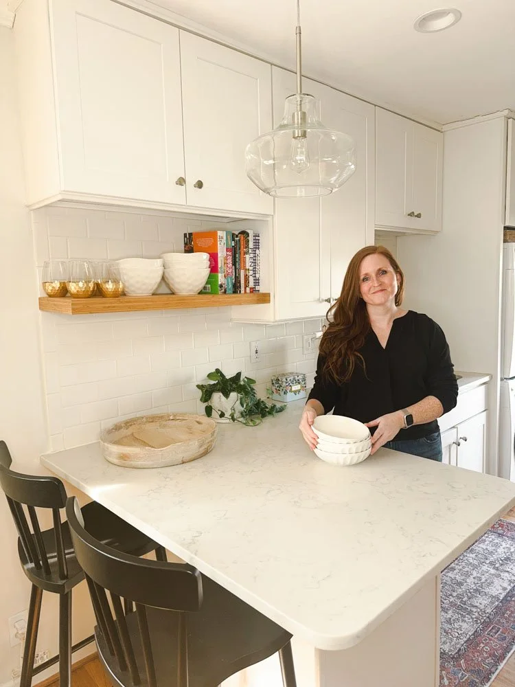 A woman standing in a kitchen with bowls on the counter