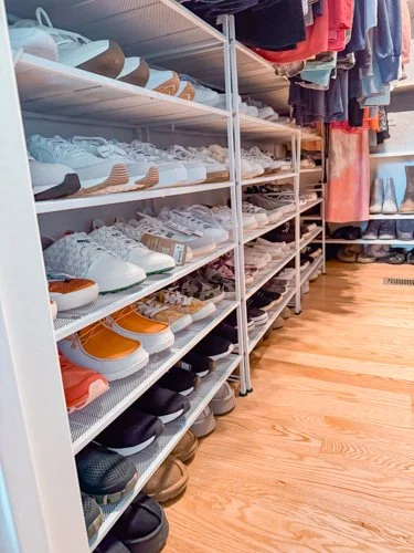 Shelves filled with various pairs of shoes in a store.