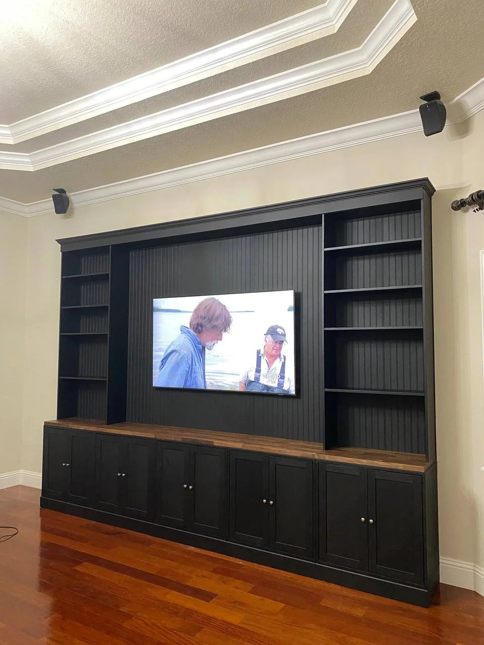 Custom media wall with built-in shelving and cabinets in Cape Coral Florida living room