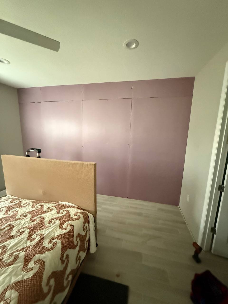 Soundproofing barrier installation in Tampa bedroom before shiplap accent wall installation