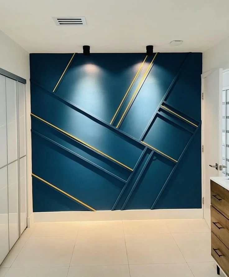 Modern interior wall with geometric blue panels and gold accents
