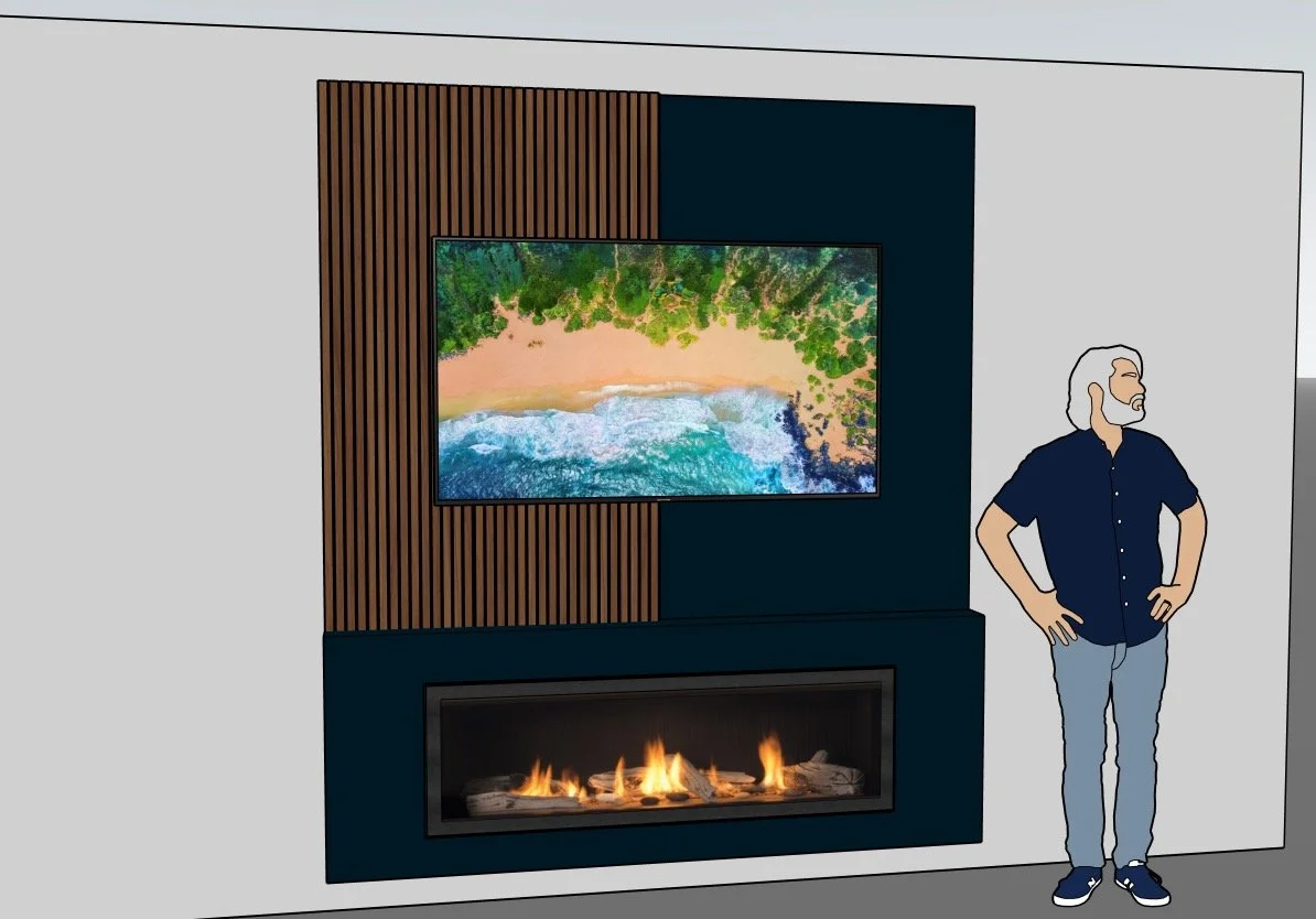 A man with gray hair and a beard standing in a living room with a modern fireplace and a large flat-screen TV on a wooden slat wall panel. The fire is burning below the TV, and the man is looking at the TV with his hands on his hips.