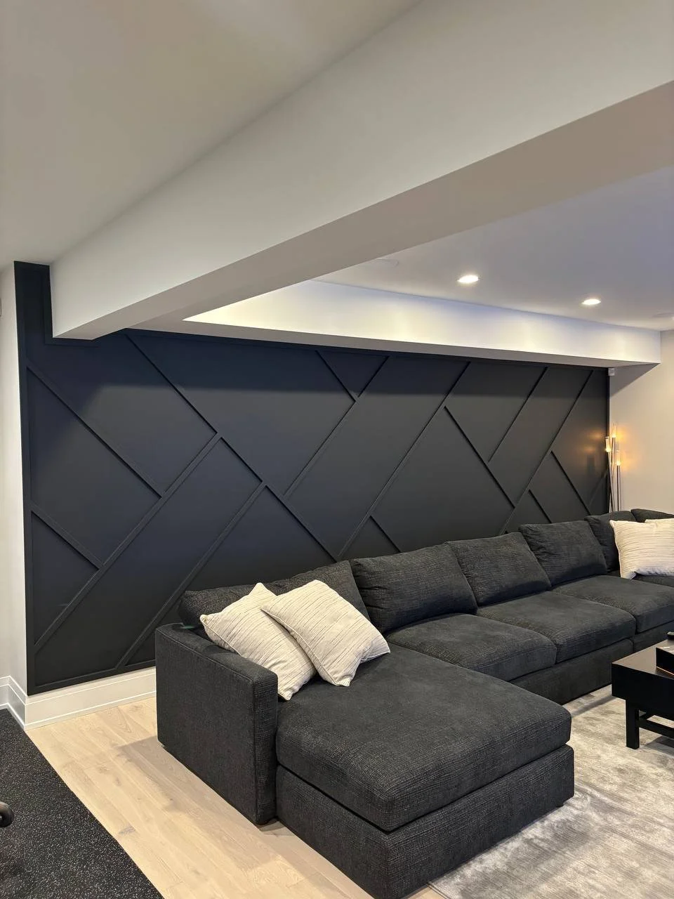 Wide angle view showcasing the contrast between black wall design, white ceiling, and soft lighting.