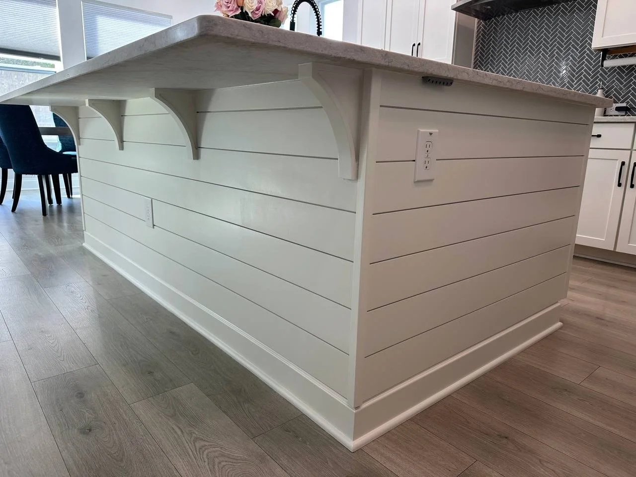 Custom kitchen island with horizontal shiplap and decorative brackets in Lakewood Ranch FL