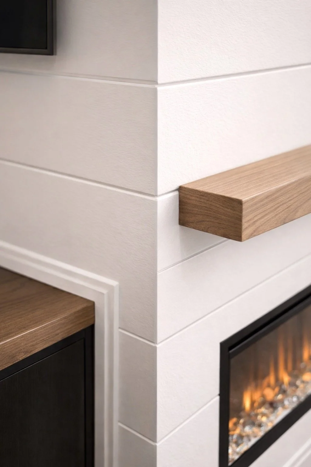 Close-up of fireplace wall corner showing precise trim, seamless joints, and smooth paint finish