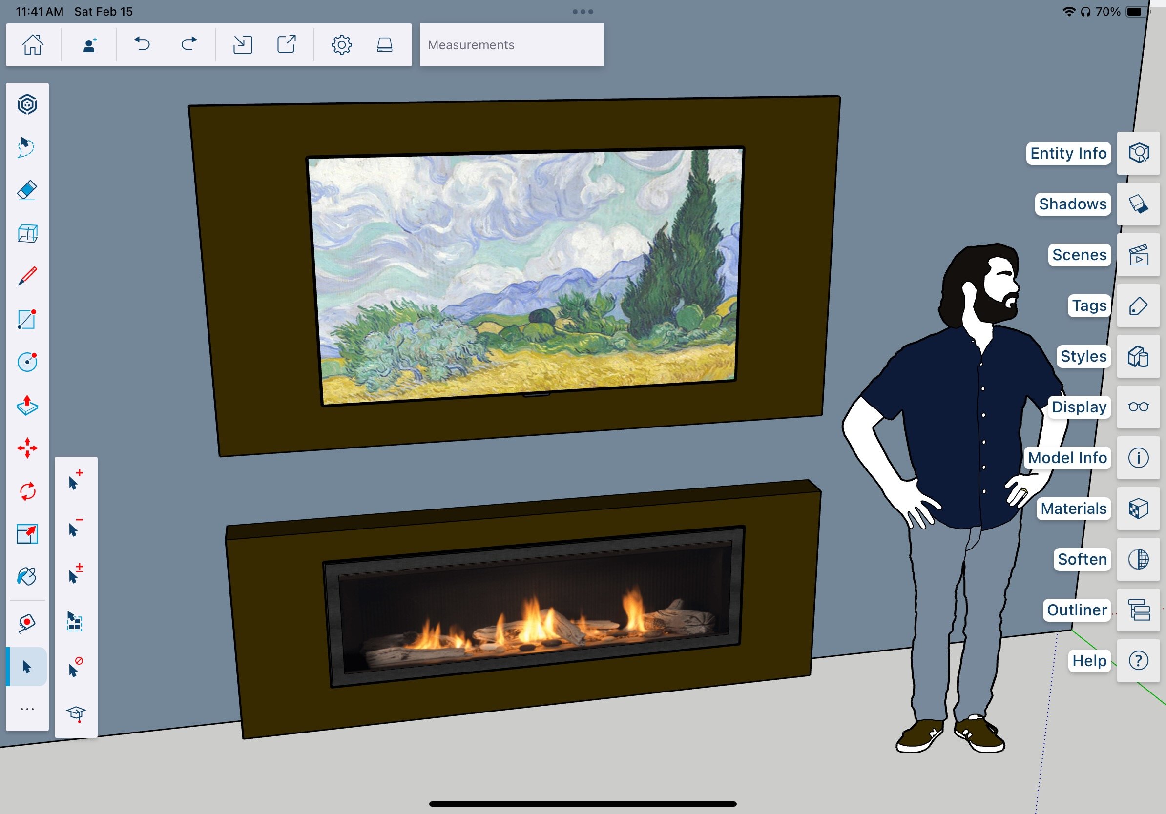 Computer 3D modeling scene of a living room with a framed landscape painting of a cloudy sky, green trees, and mountains hung above a modern rectangular fireplace with flames, and a man standing with hands on hips wearing a dark shirt, gray pants, an