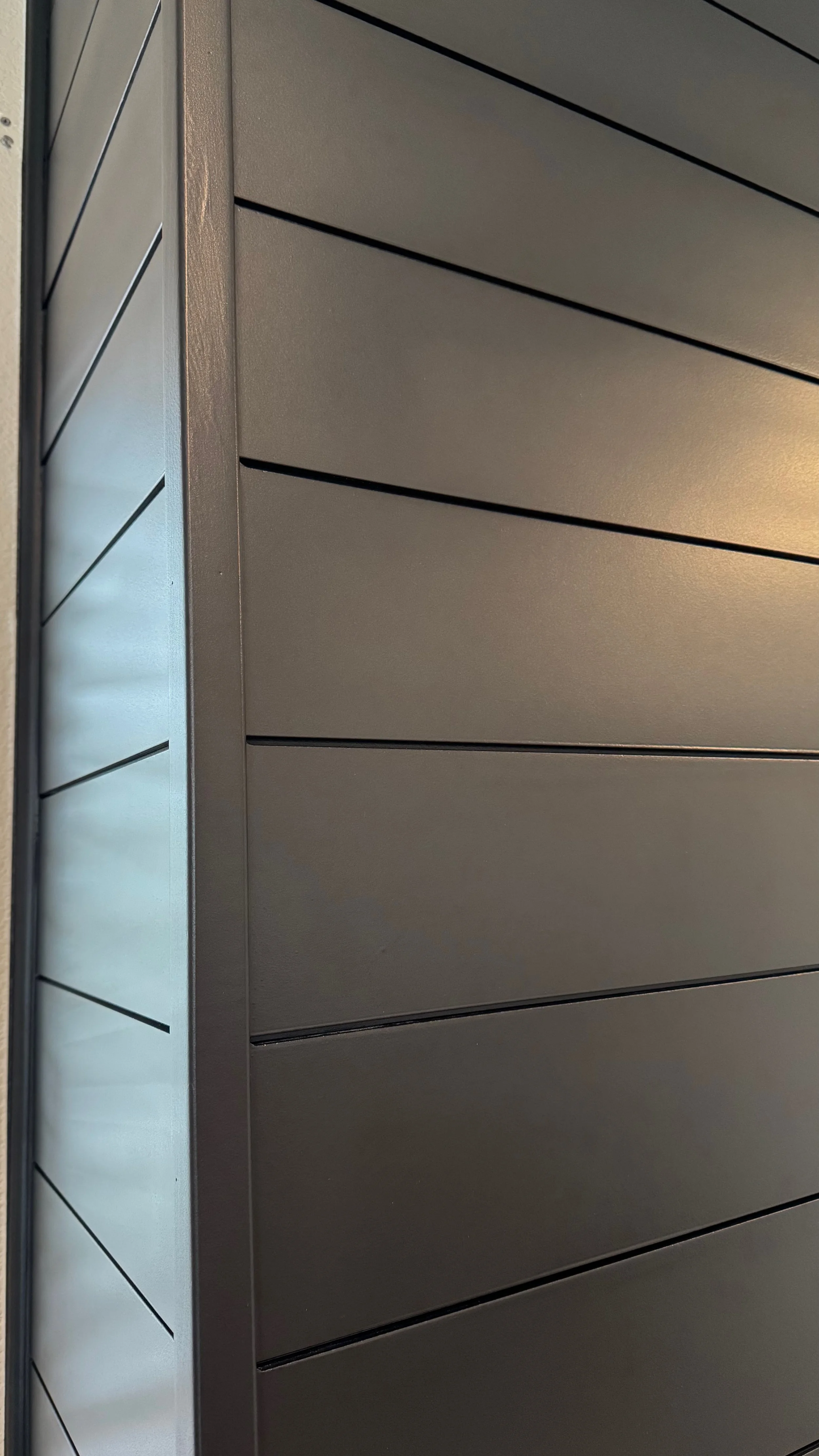 Close-up of a modern row of gray metal lockers with horizontal slot vents.