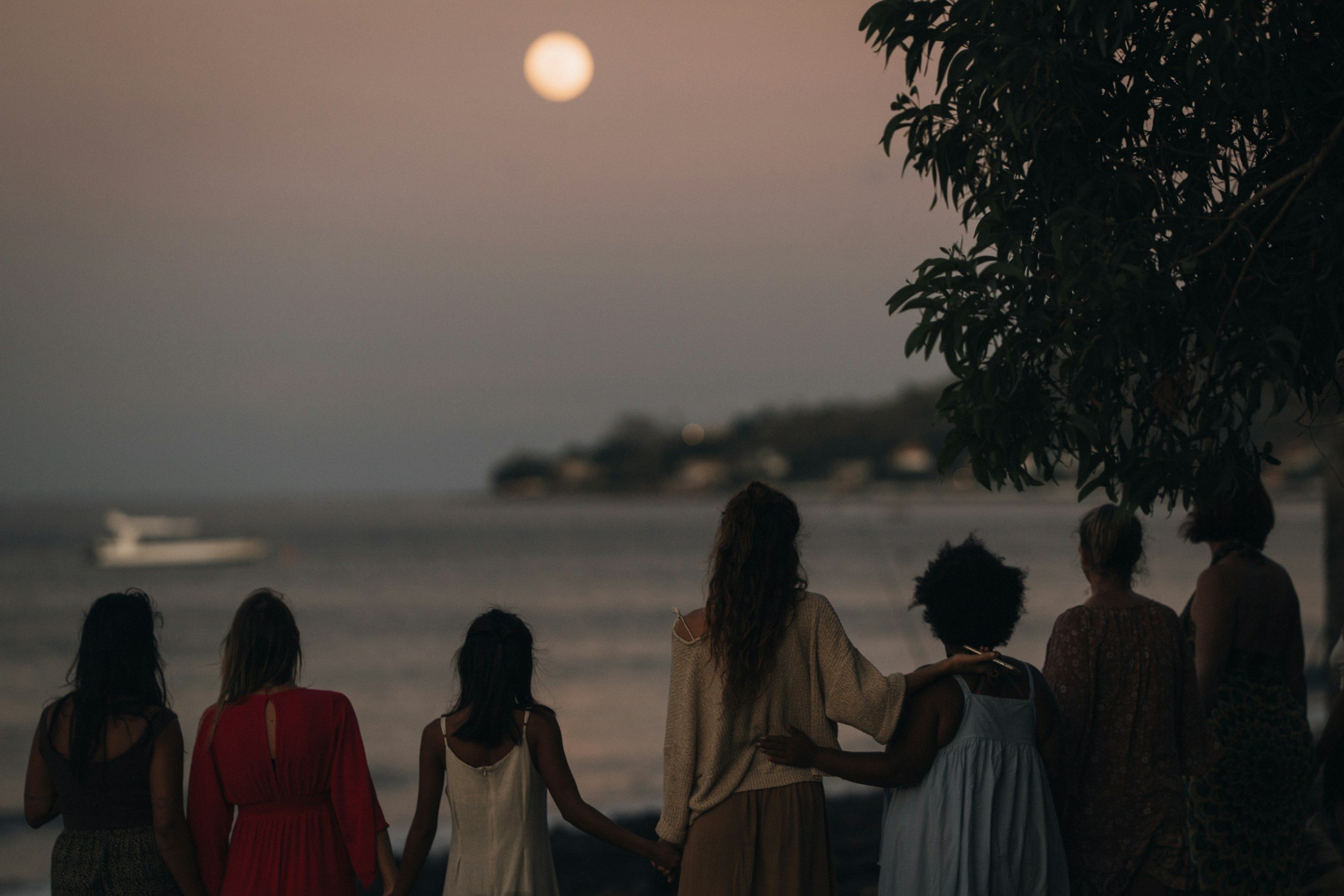 Women looking out to the sea at night