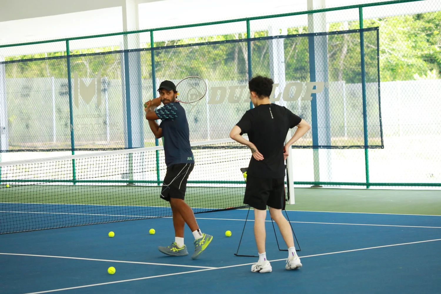 Adult tennis coaching session