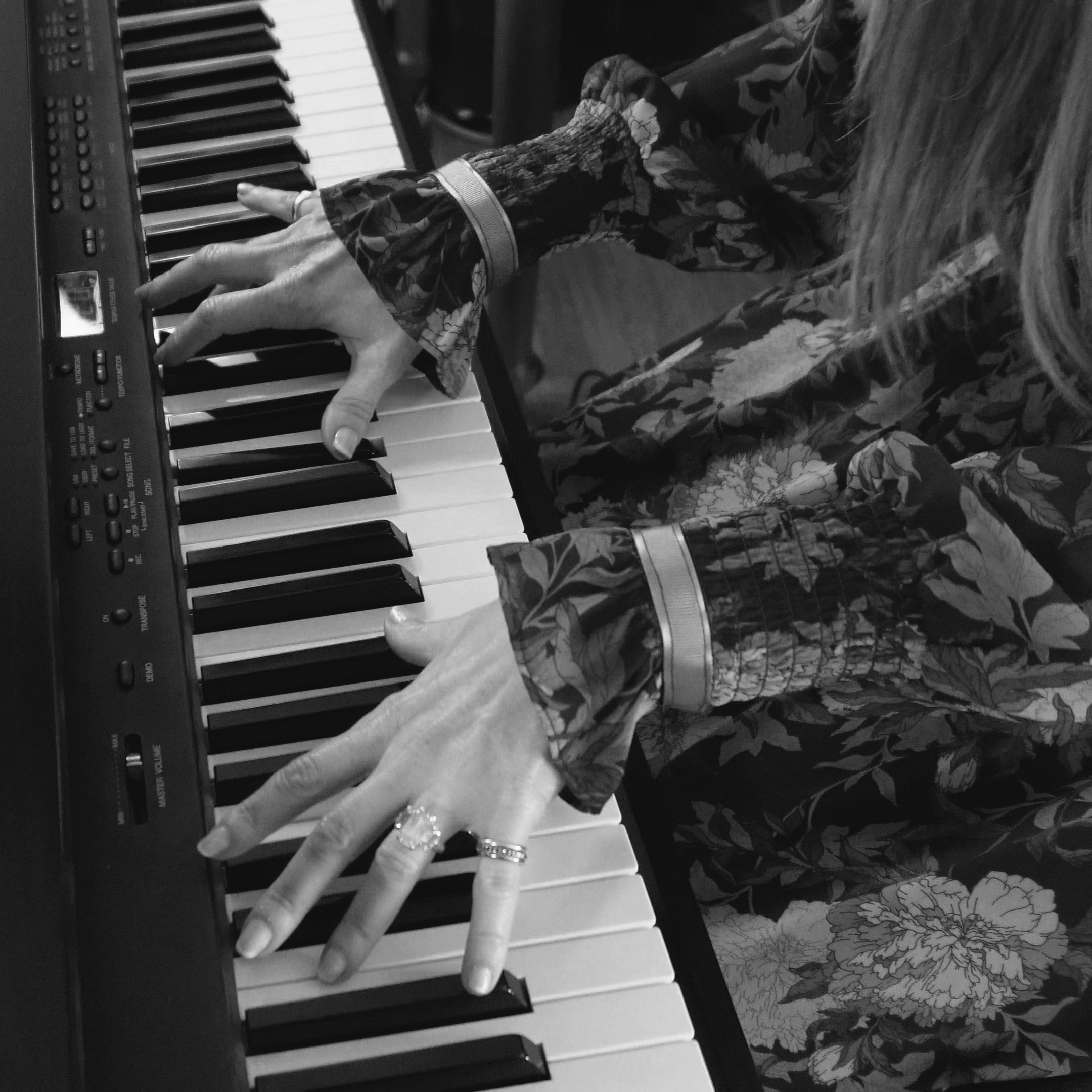 Julia Blum playing piano in her home studio.