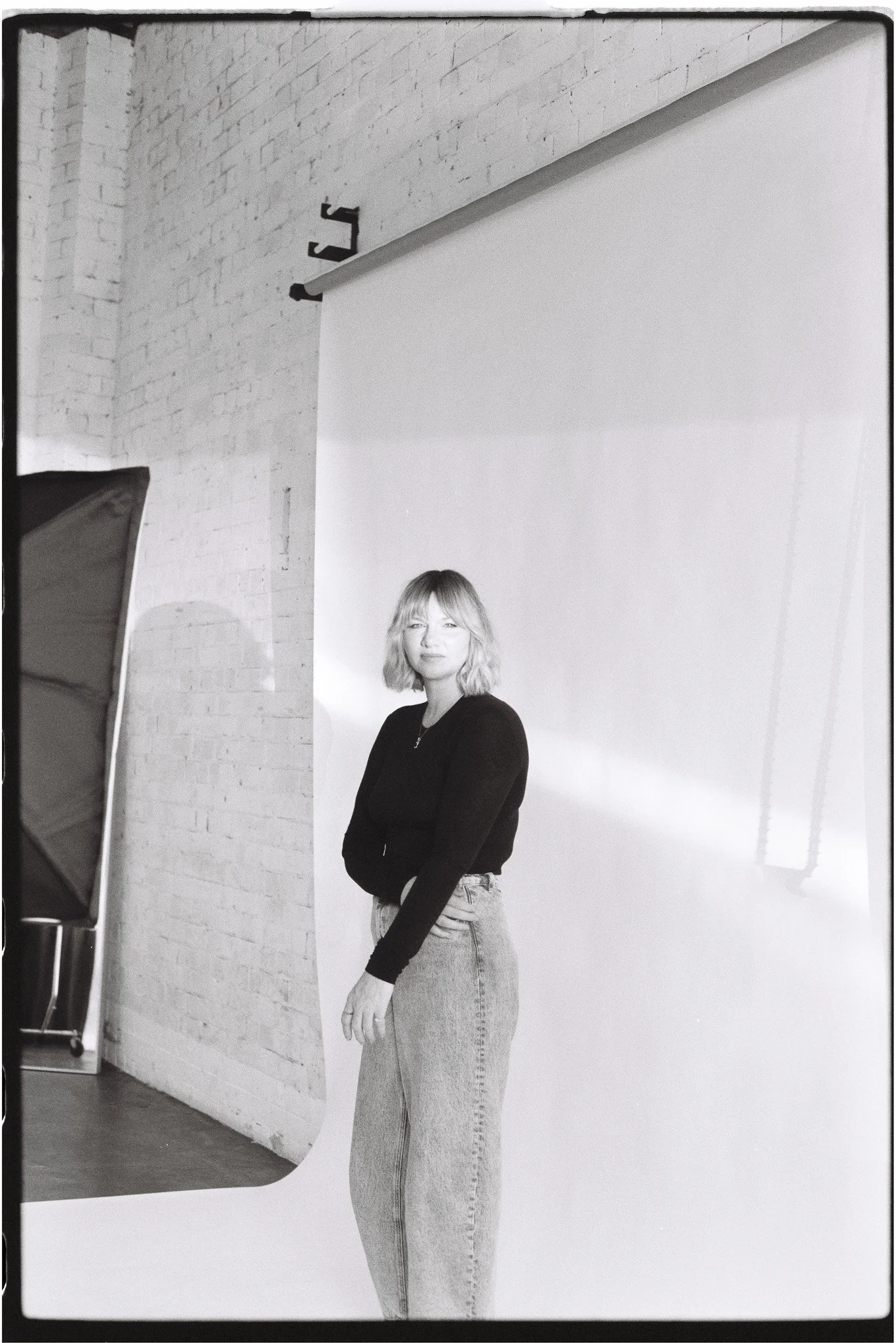Woman standing before a studio backdrop at The Station Brisbane, a streak of light crossing her face